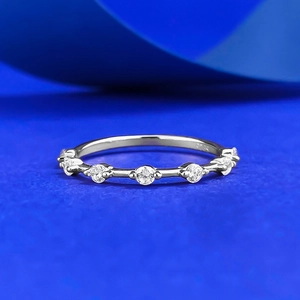 Minimalist S925 sterling silver ring with five round zircons on blue silk background