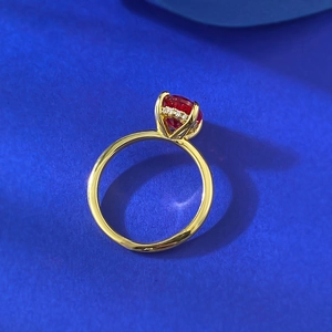 Close-up of S925 gilded ring with oval ruby and sparkling diamond halo setting