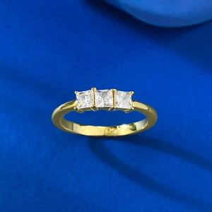 Macro view of gold-plated S925 silver ring featuring three square-cut white zircons