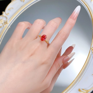 Macro shot of S925 gilded ring with 7x10mm oval ruby and four-prong setting