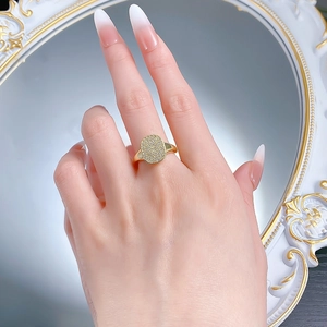 Detail of 18K gold plated S925 silver ring featuring pave cubic zirconia on model's finger