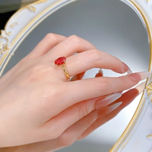 Close-up of elegant 7x10mm oval ruby gemstone ring with 18k gold plated claw setting