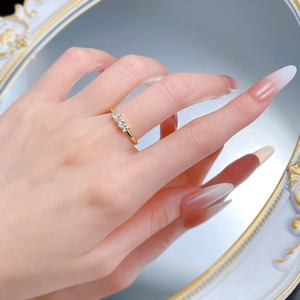 Close-up of S925 silver 3-stone ring with princess cut crystals on a female finger