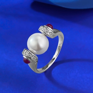 Detail showing the S925 silver hallmark and red gemstones next to a white pearl
