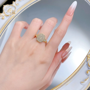 Close-up of a gold S925 silver ring with micro-pave zircon crystals in a lace design