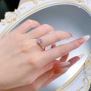Macro view of S925 silver ring with 5x7mm oval pink diamond and halo setting on finger