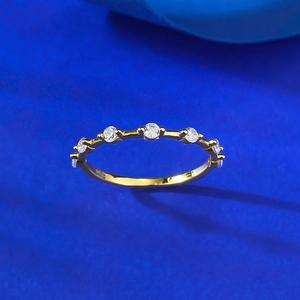Detail of minimalist gold-plated S925 silver ring set with seven sparkling zircon stones