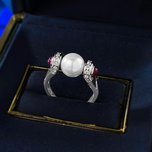 Close-up of S925 silver vintage ring with high-luster pearl and ruby accents