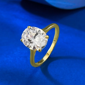 Elegant gold-tone ring with an 8x10mm oval white gemstone in a four-prong setting