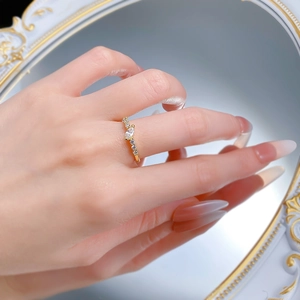 Detail of 18K gold ring featuring marquise-cut cubic zirconia and side diamond accents