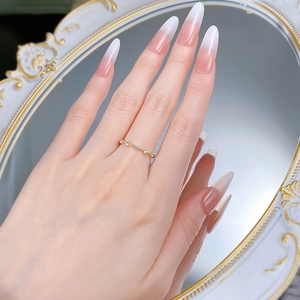 Close-up of minimalist gold plated silver band ring with five white zircon stones