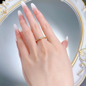 Detail of s925 silver marquise-cut zircon ring worn on finger with elegant nail art