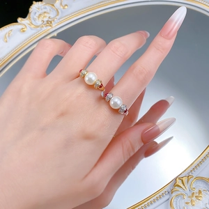 Detailed view of vintage S925 silver rings with large pearls and red gemstone accents