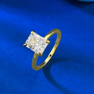 Detailed view of square-cut clear gemstone in four-prong gold plated silver setting
