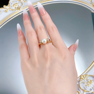 Detail of S925 silver pearl ring with ruby stones and diamonds on a vintage mirror