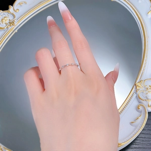 Detail of S925 sterling silver stacking ring with pave zircons on woman's finger
