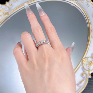Close-up of S925 silver hollow eternity ring with clear zircons worn on hand