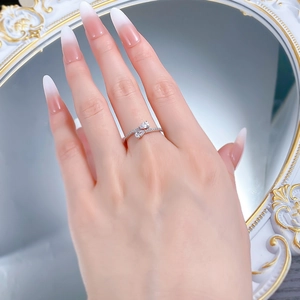 Elegant S925 silver bypass ring featuring pear-shaped stones worn on model's hand