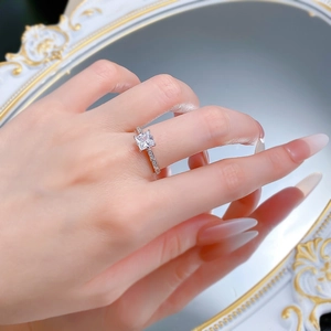 Macro detail of S925 silver princess cut ring shown on hand with elegant mirror reflection