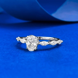 S925 sterling silver ring with oval clear gemstone and marquise side accents on blue