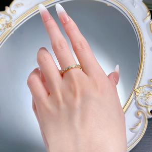 Close-up of elegant gold S925 silver ring with full pavé diamonds worn on finger