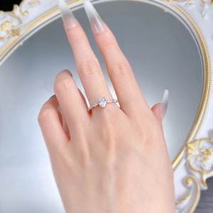 Macro detail of oval cut gemstone ring with marquise side stones on a S925 silver band