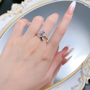 Detailed close-up of a silver oval-cut zircon open ring worn on a model's hand