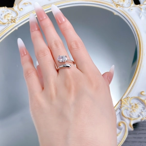 Close-up of S925 silver oval cubic zirconia ring with bypass open band on hand
