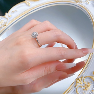 Macro view of S925 silver halo ring with round brilliant cut sparkling center stone