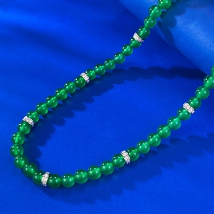 Close-up of a green chalcedony bead necklace with silver diamond-encrusted accents