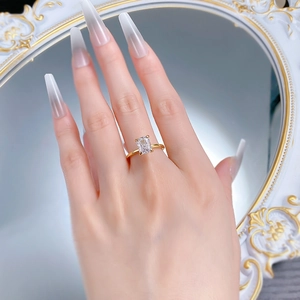 Macro detail of gold S925 silver ring with 6x8mm rectangular ice cut stone on a hand