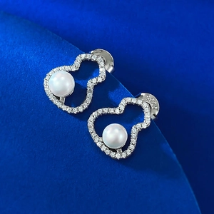 Detailed macro view of S925 silver wulu stud earring with white pearl and crystals