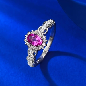 Elegant S925 silver ring with oval pink gemstone and halo diamonds on navy silk background