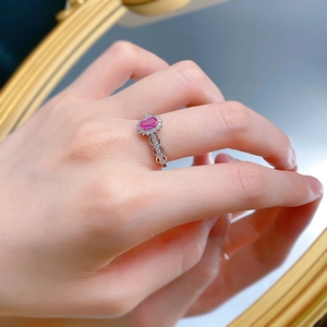 Close-up of S925 silver ring featuring pink sapphire with halo stones and wave band
