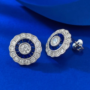 Macro view of 925 silver round earrings with blue stones and halo of sparkling diamonds