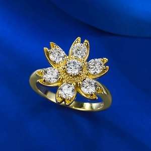 Macro shot of gold-plated daisy flower ring with sparkling white cubic zirconia stones