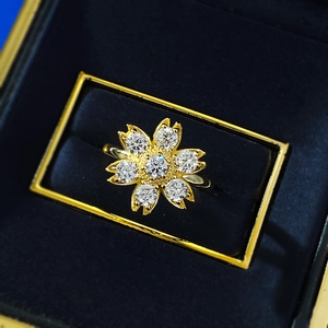 Elegant gold daisy ring with sparkling crystals in a premium blue velvet jewelry box