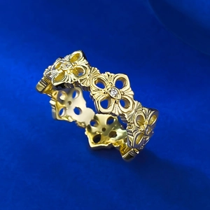 Luxurious gold hollow floral band ring featuring intricate vintage carvings and white stones