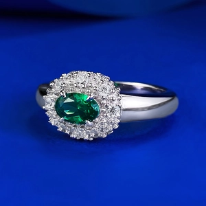 Elegant S925 silver halo ring featuring an oval green emerald and white accent stones
