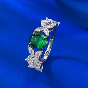 S925 silver ring featuring an oval green emerald zircon with floral cluster marquise accents