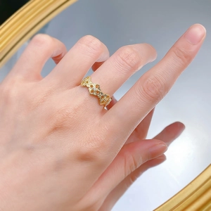 Close-up of gold plated 925 silver ring with镂空 baroque patterns and crystal inlay