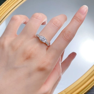 Detail of an S925 silver ring with a 2-carat oval gemstone and pavé diamonds on the band