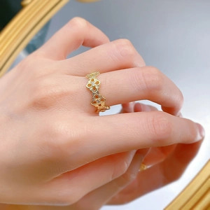 Detailed close-up of 925 silver gold-plated hollow floral ring with zircon inlay