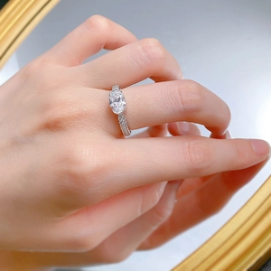Detailed close-up of 2-carat oval crystal ring with micro-pave silver band