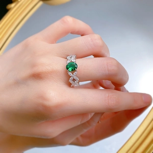 Detailed 45-degree angle of S925 silver ring with oval green zircon and floral accents