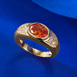 Macro view of gold-plated S925 silver ring featuring an oval orange ice-cut main stone