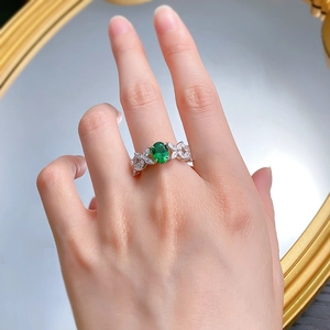 Macro detail of S925 silver ring featuring an oval green gemstone and white zircon stones