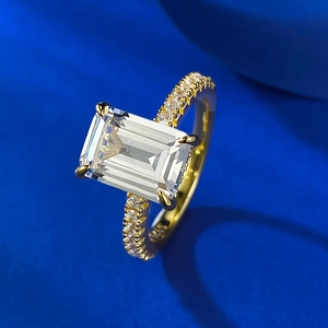 Macro detail of S925 sterling silver ring with emerald cut stone and side pave diamonds
