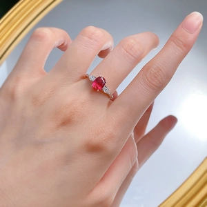 S925 silver ring with 6x8mm oval ruby and pear-cut side stones on finger