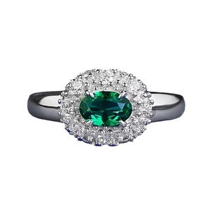 Classic oval green gemstone ring with double halo of diamonds on silver band